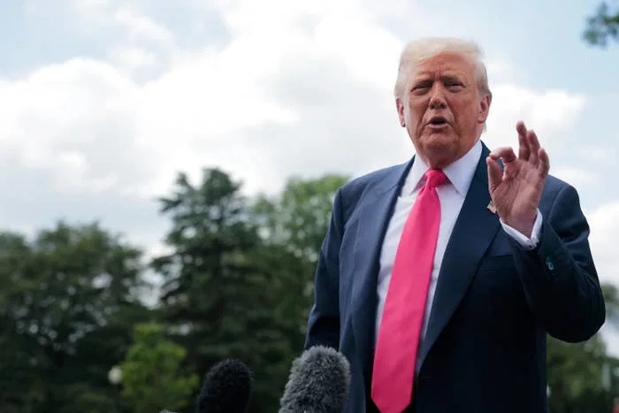 U.S. President Donald Trump speaks to the media as he departs the White House