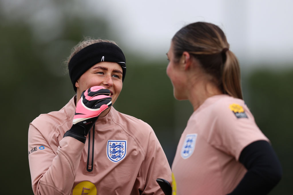 Hannah Hampton of England talks with teammate Mary Earps during a Training Session at the England Women June International Camp on July 01, 2024 in Noordwijk aan Zee, Netherlands.