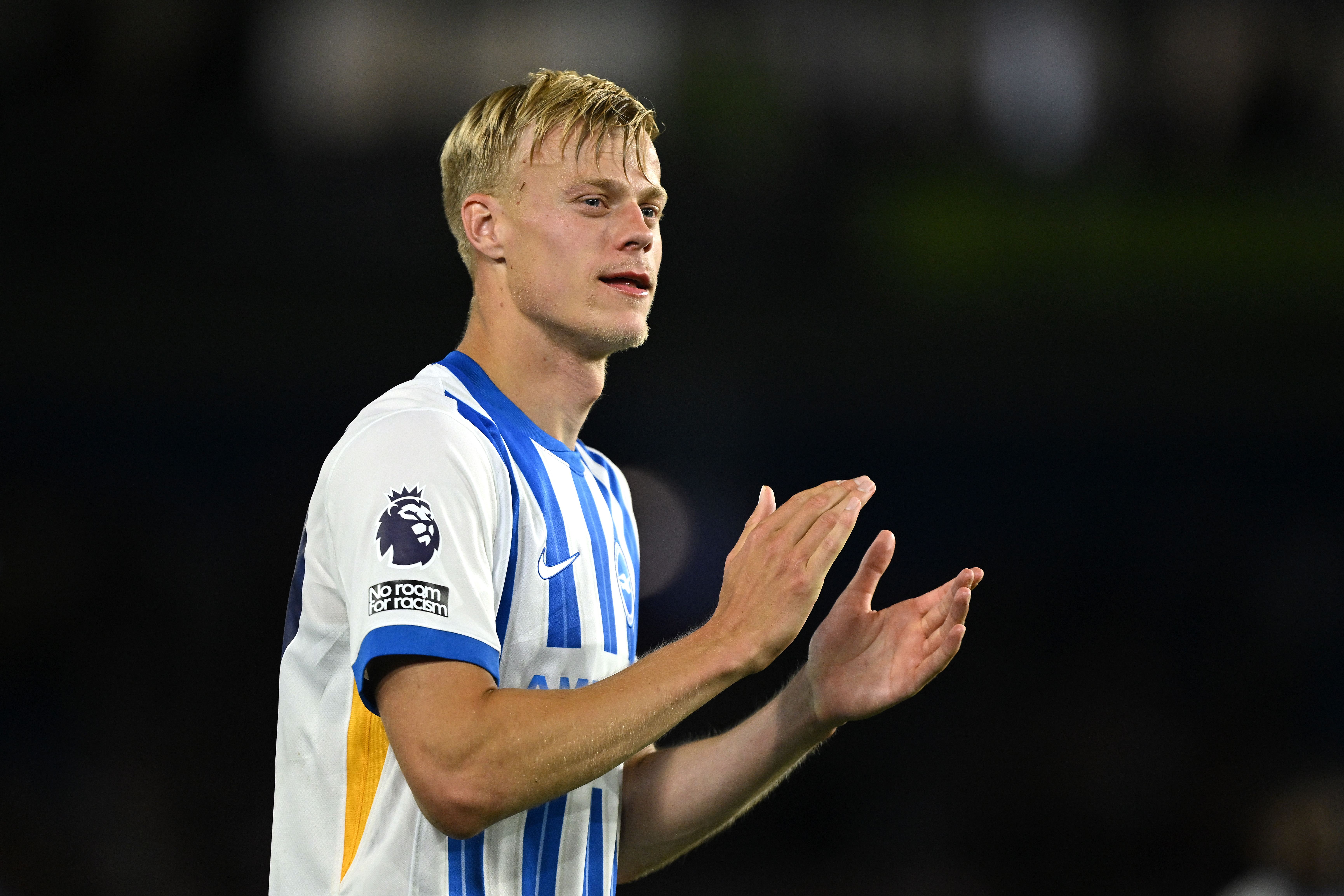 Jan Paul van Hecke applauds whilst appearing for Brighton