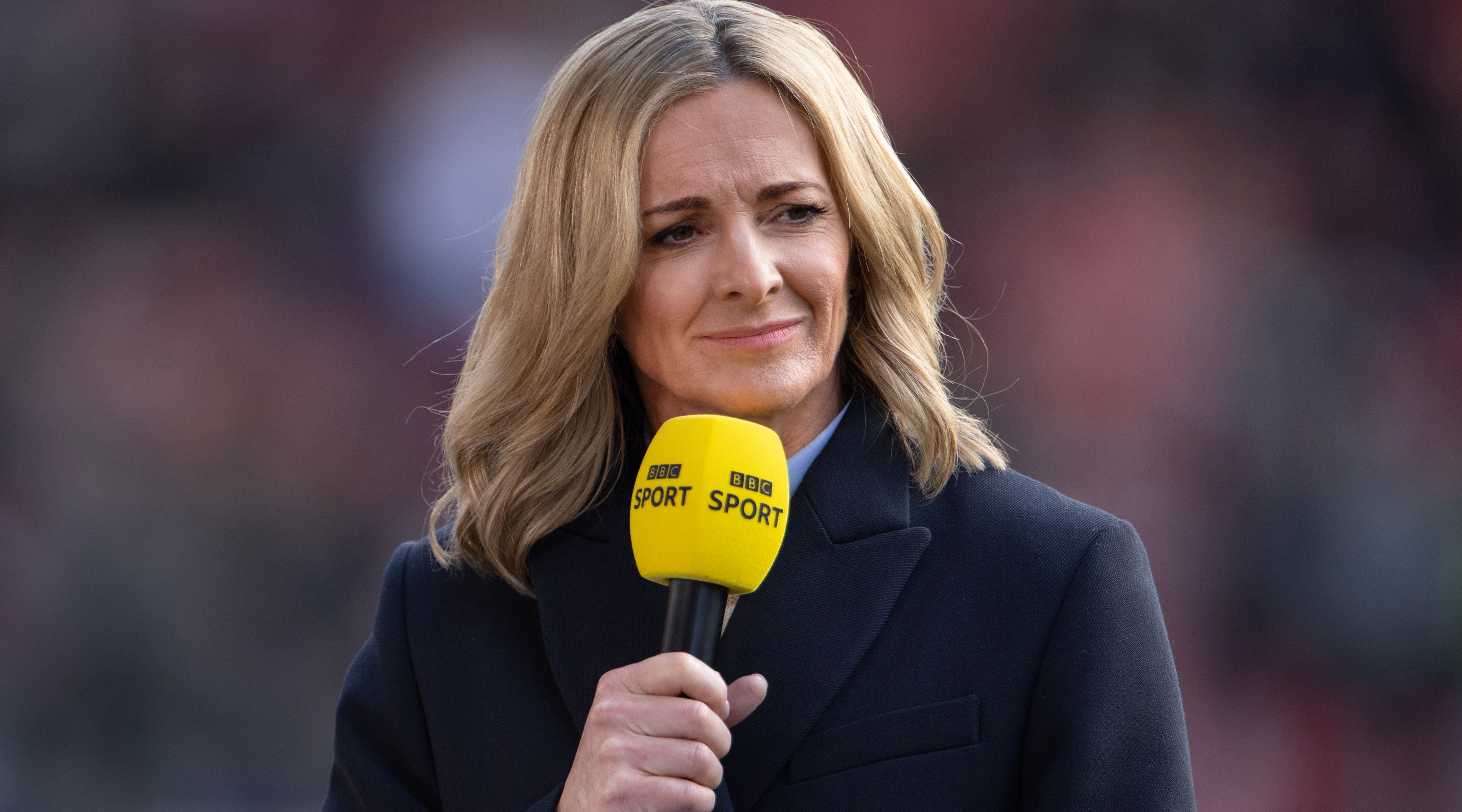 Gabby Logan holding a BBC Sport microphone