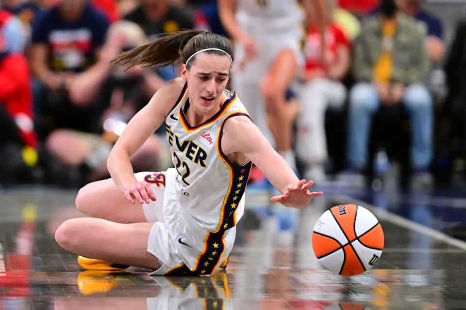 Indiana Fever's Caitlin Clark goes for a loose ball during the first half of a WNBA basketball game against Golden State Valkyries, Wednesday, July 9, 2025, in Indianapolis. (AP Photo/Doug McSchooler)