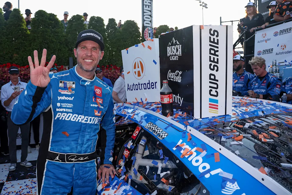 DOVER, DELAWARE - JULY 20: Denny Hamlin, driver of the #11 Progressive Toyota, poses with the winner sticker on his car in victory lane after winning  the NASCAR Cup Series AutoTrader EchoPark Automotive 400 at Dover Motor Speedway on July 20, 2025 in Dover, Delaware. (Photo by Meg Oliphant/Getty Images)