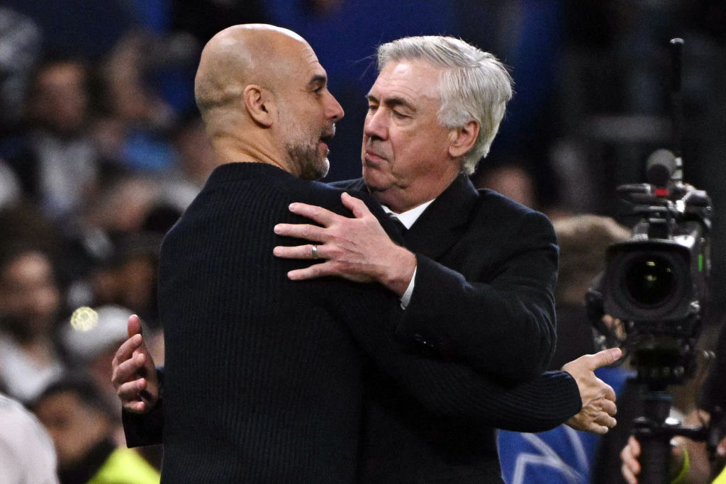 Manchester City's Spanish coach Pep Guardiola and Real Madrid's Italian coach Carlo Ancelotti hug each other at the end of the UEFA Champions League knockout phase play-off football match between Real Madrid CF and Manchester City at the Santiago Bernabeu stadium in Madrid on February 19, 2025. (Photo by JAVIER SORIANO / AFP) (Photo by JAVIER SORIANO/AFP via Getty Images)