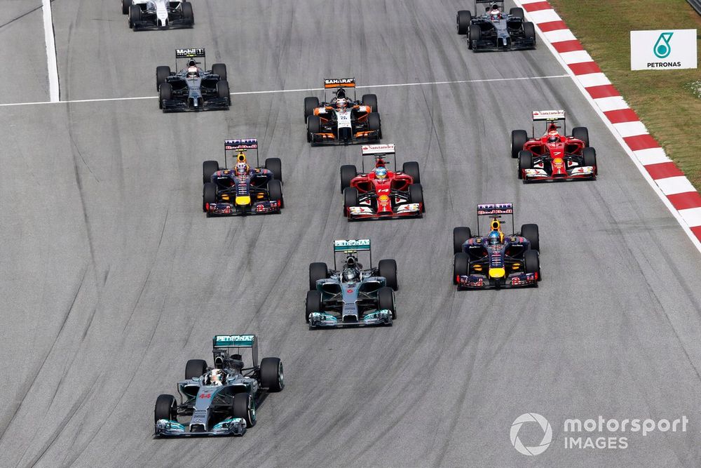 Lewis Hamilton, Mercedes W05, leads Nico Rosberg, Mercedes W05, Sebastian Vettel, Red Bull Racing RB10 Renault, Fernando Alonso, Ferrari F14T, Daniel Ricciardo, Red Bull Racing RB10 Renault, Kimi Raikkonen, Ferrari F14T, Nico Hulkenberg, Force India VJM07 Mercedes, and Kevin Magnussen, McLaren MP4-29 Mercedes, at the start