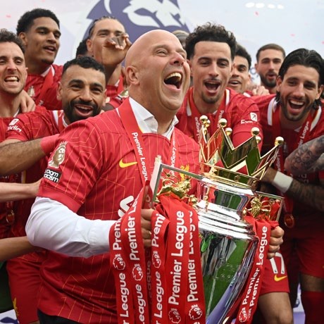LIVERPOOL, ENGLAND - MAY 25: Arne Slot, Manger of Liverpool, lifts the Premier League trophy, as Liverpool are crowned the Champions of the Premier League, following the Premier League match between Liverpool FC and Crystal Palace FC at Anfield on May 25, 2025 in Liverpool, England. (Photo by Michael Regan/Getty Images/Getty Images For The Premier League)