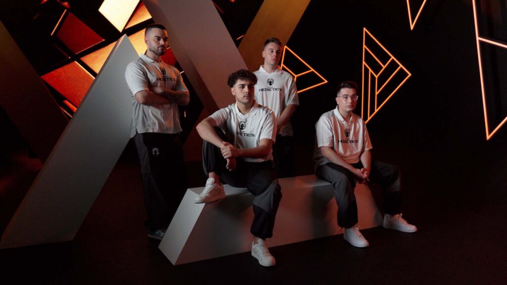 Image of Miami Heretics wearing Team Heretics jerseys while posing for photographs on a black and gold background