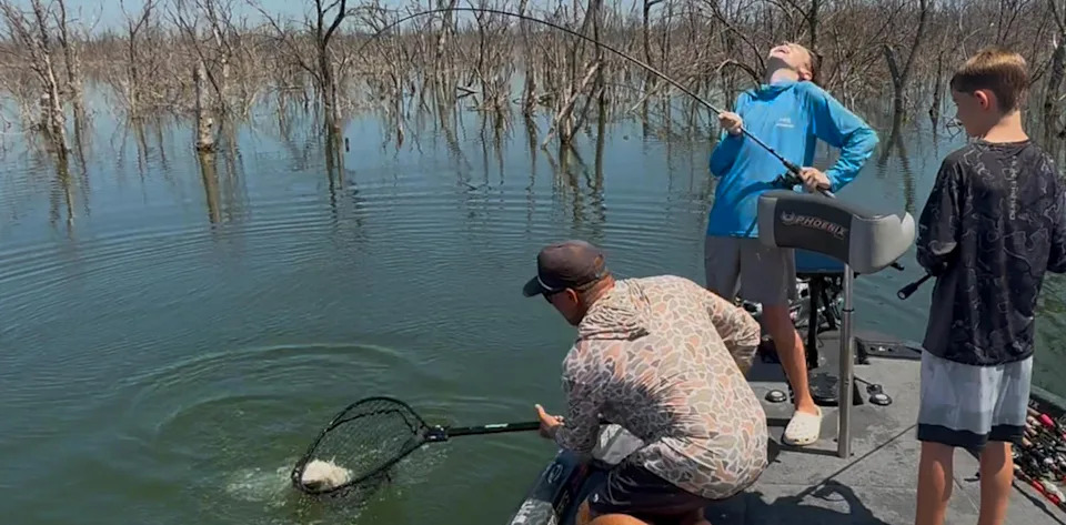 A guide nets a fish boatside.