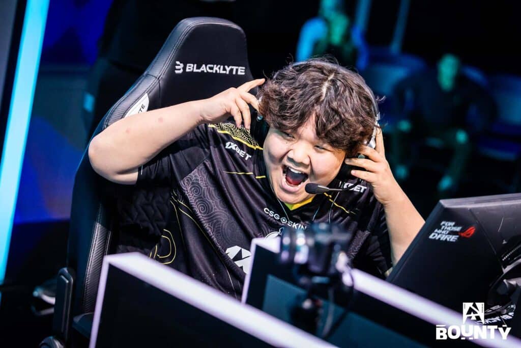 Image of The MongolZ Counter Strike player smiling while holding a headset