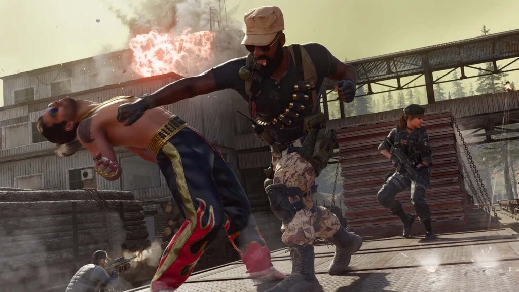 Image of Warzone players fighting with an explosion in the background