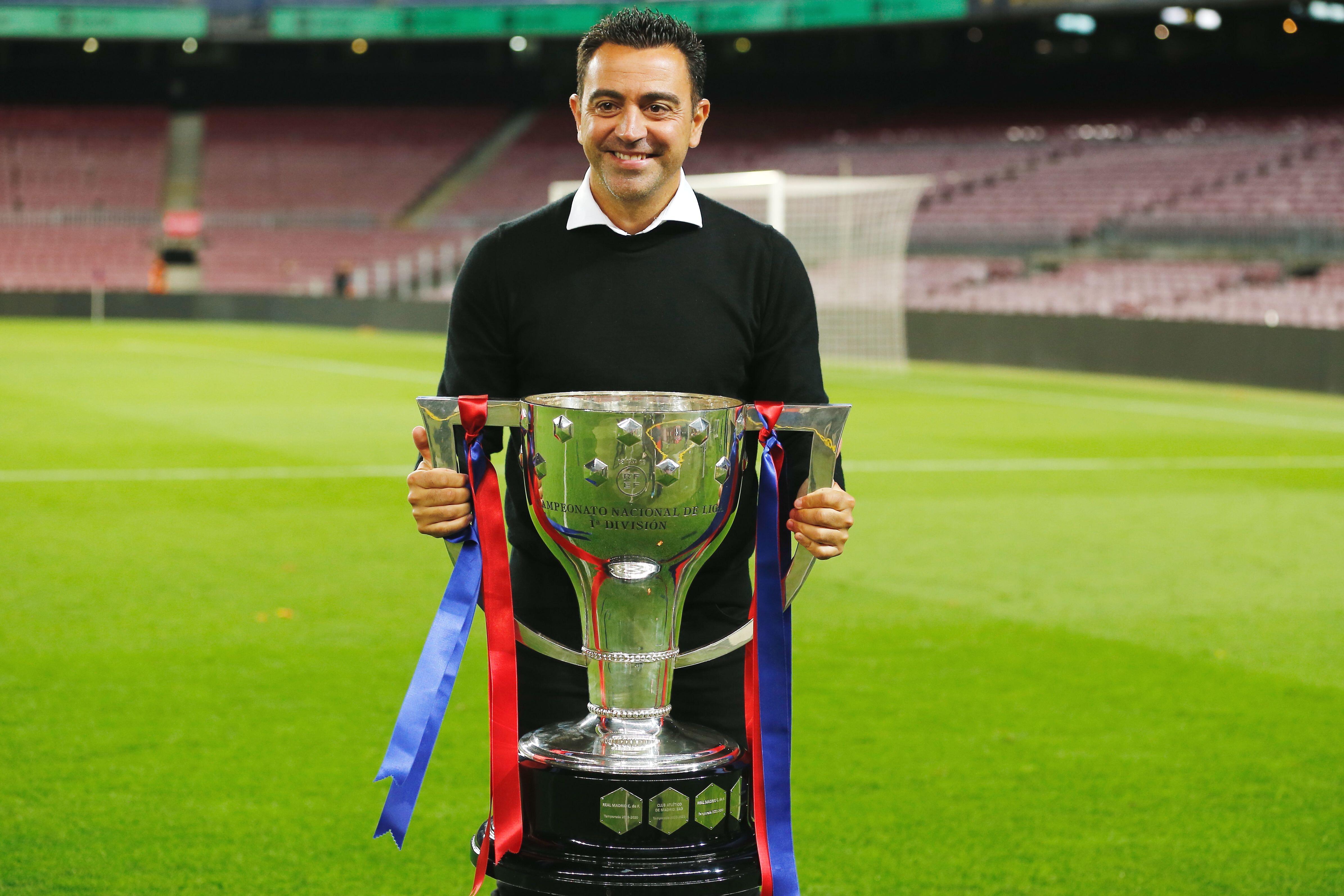 Barcelona manager Xavi poses with the LaLiga trophy, 2023