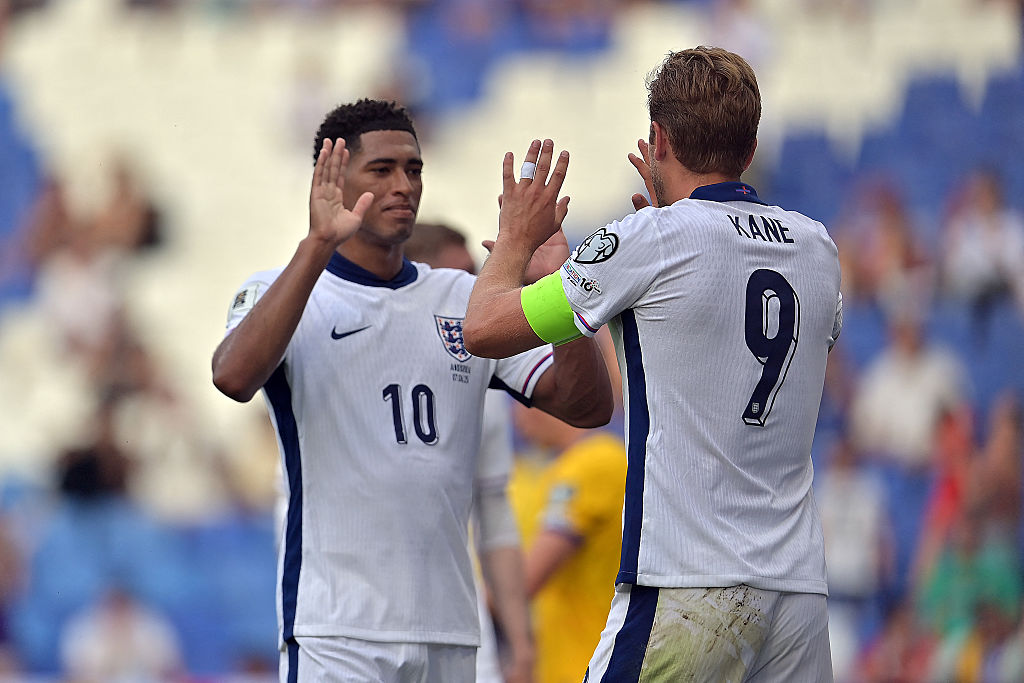 Harry Kane slaps hands with England's midfielder #10 Jude Bellingham as he celebrates scoring a goal during the 2026 World Cup qualifiers Europe zone, 1st round group K football match between Andorra and England at RCDE Stadium in Cornella de Llobregat, on June 7, 2025.