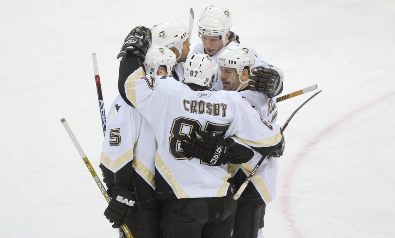 Sidney Crosby, 87, commemorates his 200th career point during a March 2, 2007, match, alongside colleagues, encompassing Alain Nasreddine, positioned second from the left.