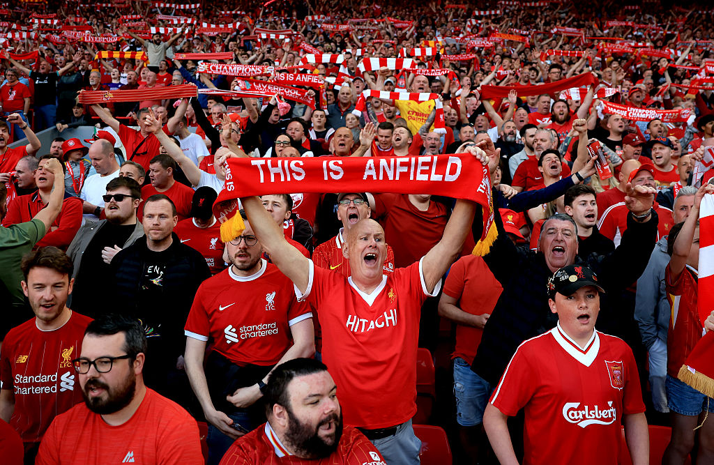Fans of Liverpool hold up scarfs, as they sign 'You'll Never Walk Alone' during the Premier League match between Liverpool FC and Tottenham Hotspur FC at Anfield on April 27, 2025 in Liverpool, England