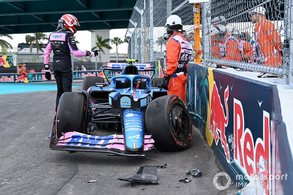 Marshals assist Esteban Ocon, Alpine A522, after a crash