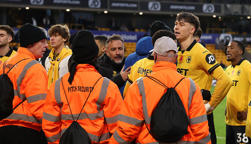 WOLVERHAMPTON, ENGLAND - OCTOBER 26: Vitor Pereira, the Wolverhampton Wanderers manager (C) and club captain, Jorgen Strand Larsen held after clashing with supporters after their defeat during the Premier League match between Wolverhampton Wanderers and Burnley at Molineux on October 26, 2025 in Wolverhampton, England. (Photo by David Rogers/Getty Images)