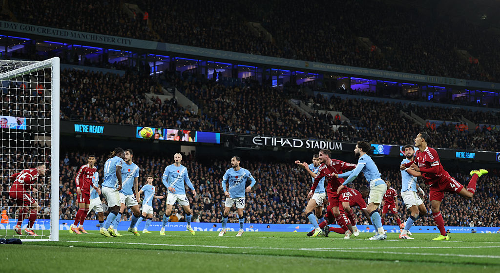 Liverpool's Dutch defender #04 Virgil van Dijk heads the ball in but the goal is dissallowed for offside against Liverpool's Scottish defender #26 Andrew Robertson (L) during the English Premier League football match between Manchester City and Liverpool at the Etihad Stadium in Manchester, north west England, on November 9, 2025. (Photo by Darren Staples / AFP) / RESTRICTED TO EDITORIAL USE. No use with unauthorized audio, video, data, fixture lists, club/league logos or 'live' services. Online in-match use limited to 120 images. An additional 40 images may be used in extra time. No video emulation. Social media in-match use limited to 120 images. An additional 40 images may be used in extra time. No use in betting publications, games or single club/league/player publications. /