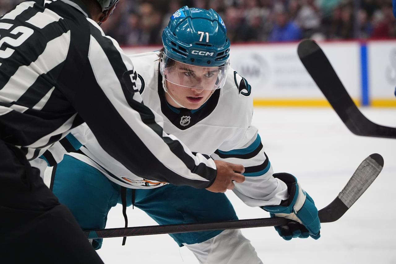 A hockey player prepares to take a faceoff.