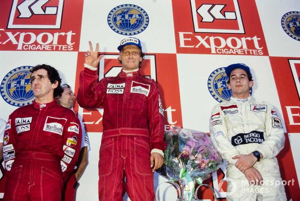 Lauda is crowned as 1984's champion - flanked by two future title winners