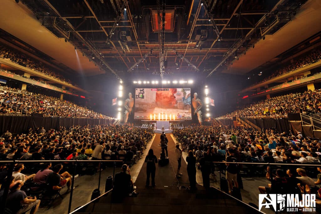 Image of Counter-Strike 2 esports event illuminated by pyrotechnics and white lighting