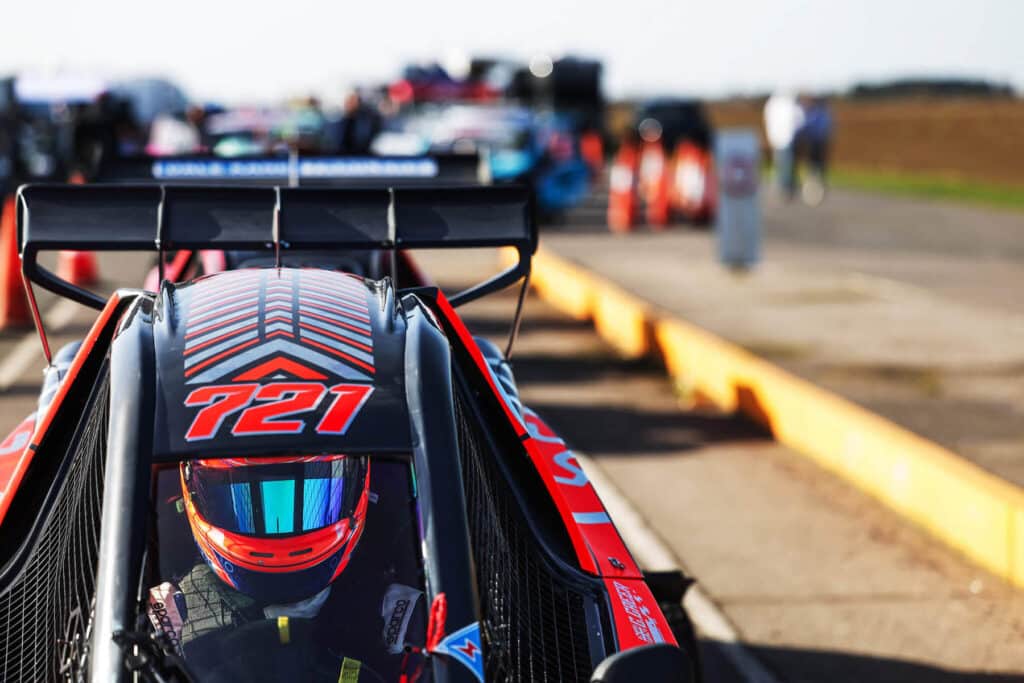 Image of Cross Car racing driver sat in seat