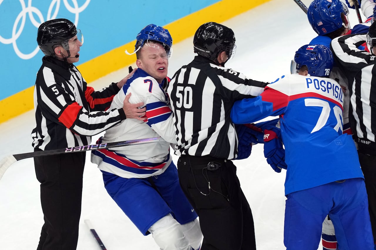 Hockey players scuffle on the ice.
