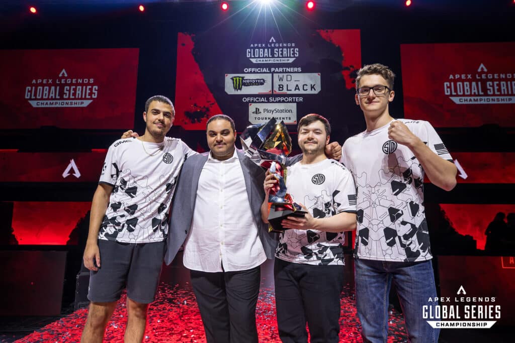 TSM roster and coach hoisting the ALGS Year 3 Championship trophy on stage 