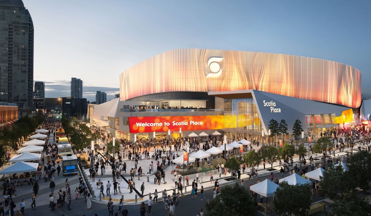 An extensive stadium structure is surrounded by lively crowds.