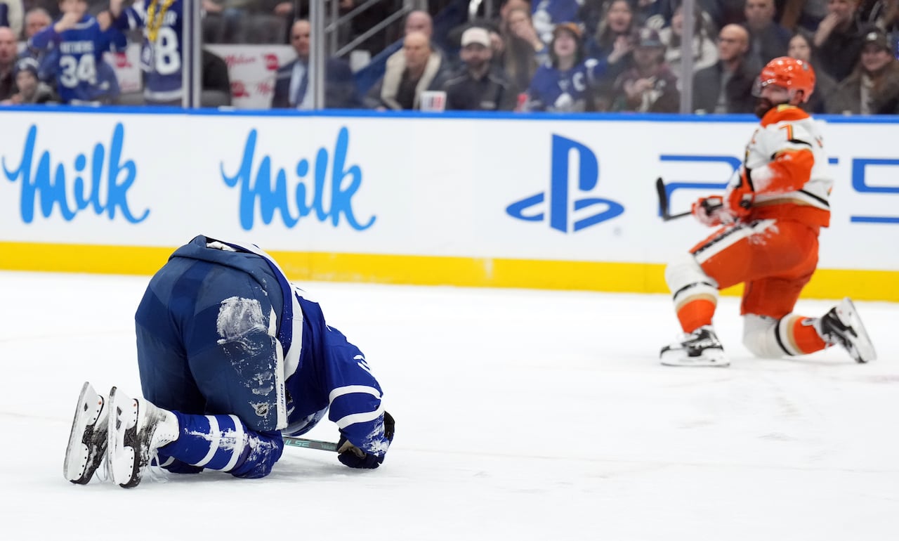 A hockey player reacts to getting injured.