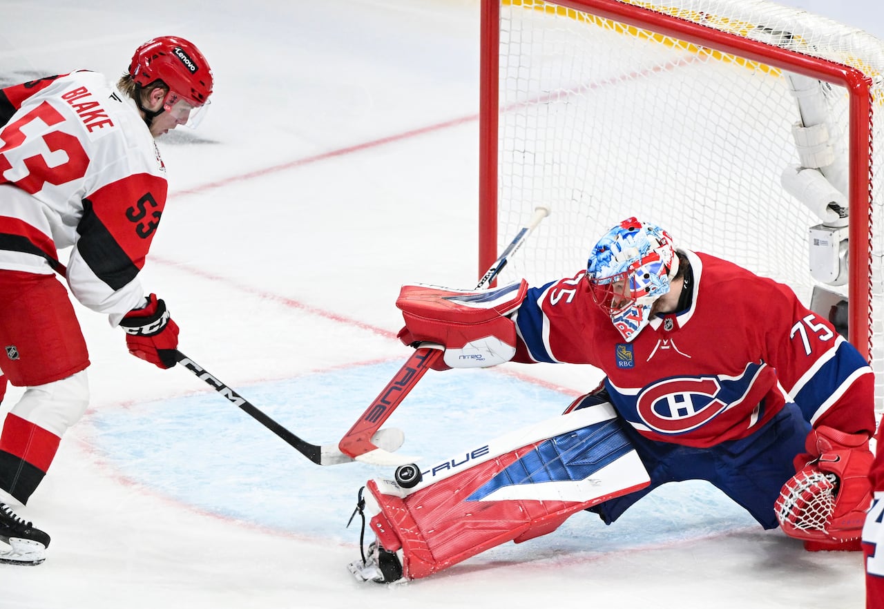 Montreal Canadiens goaltender Jakub Dobes (75) stops Carolina Hurricanes' Jackson Blake (53).