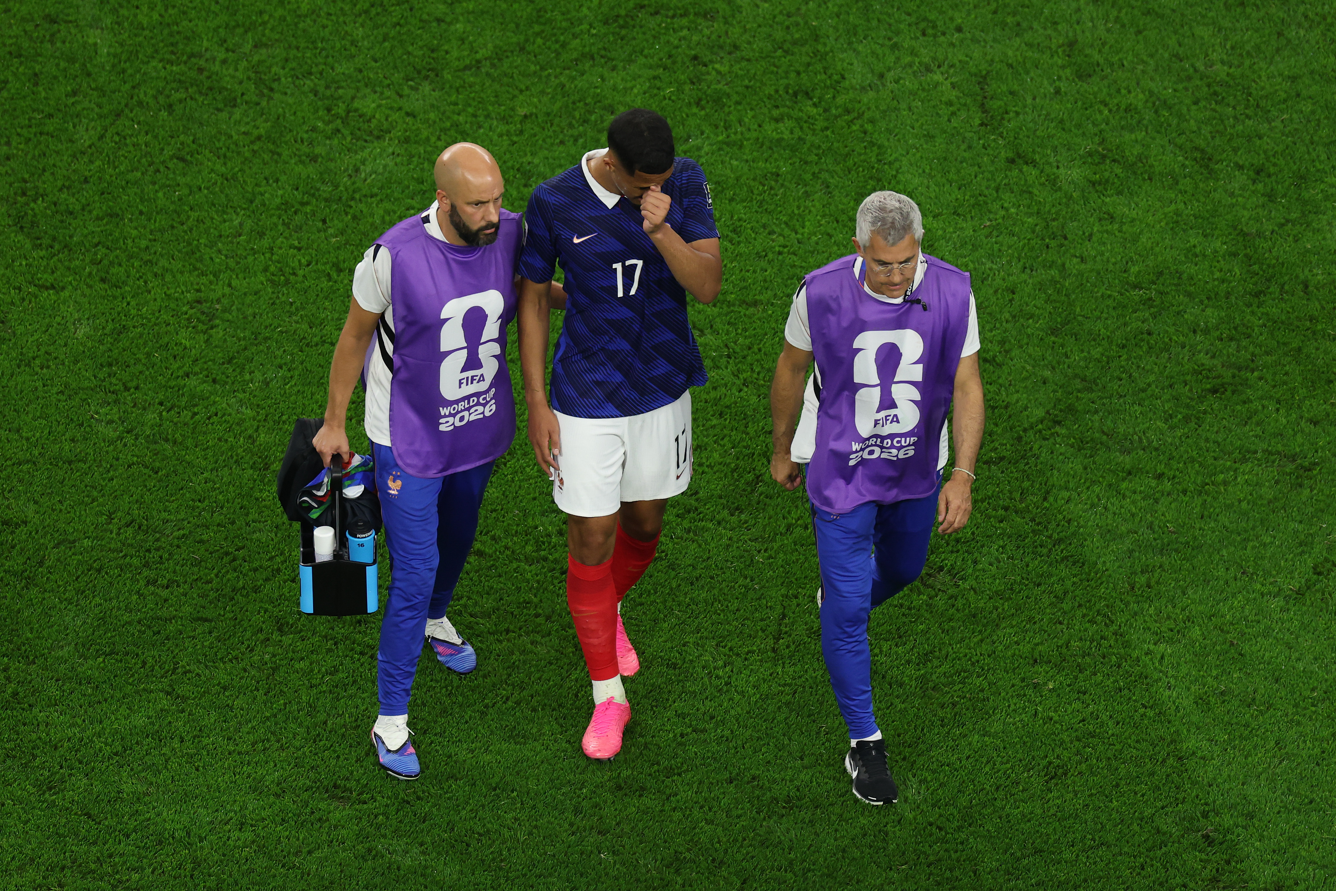 ARLINGTON, TEXAS - JULY 14: William Saliba #17 of France walks off the pitch with medical staff after sustaining an injury during the FIFA World Cup 2026 Semi Final match between France and Spain at Dallas Stadium on July 14, 2026 in Arlington, Texas. (Photo by Kevin C. Cox/Getty Images)