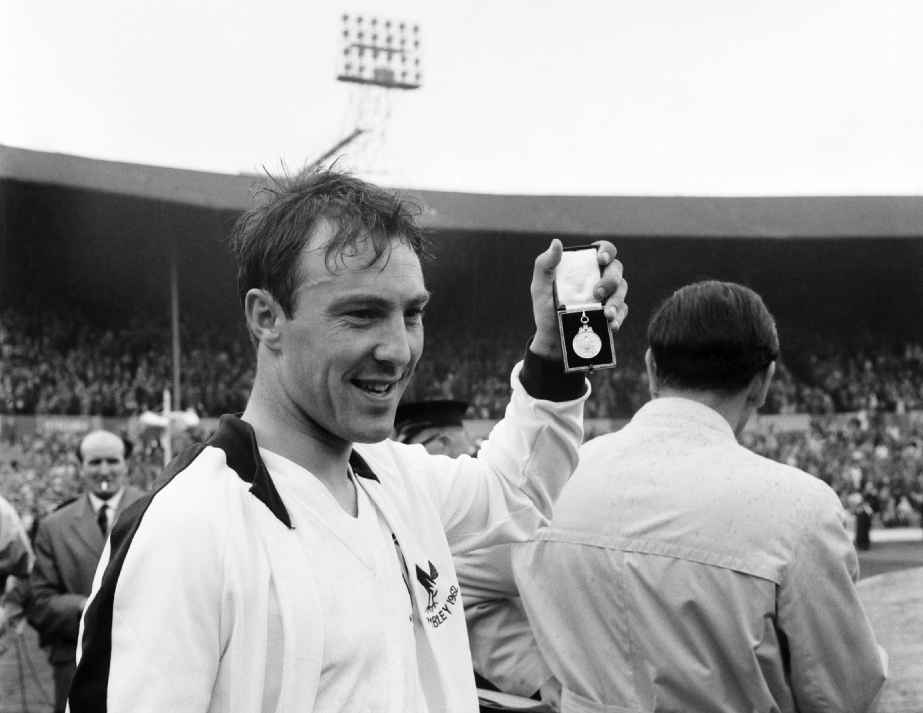 Jimmy Greaves celebrates with his winner's medal following Tottenham's FA Cup final triumph against Burnley in 1962