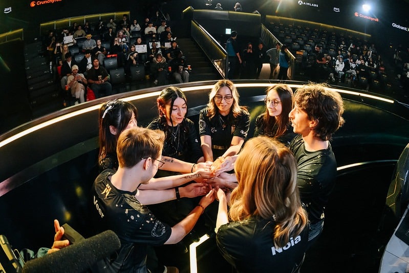 Shopify Rebellion's VALORANT Game Changers team huddling on stage at a global event
