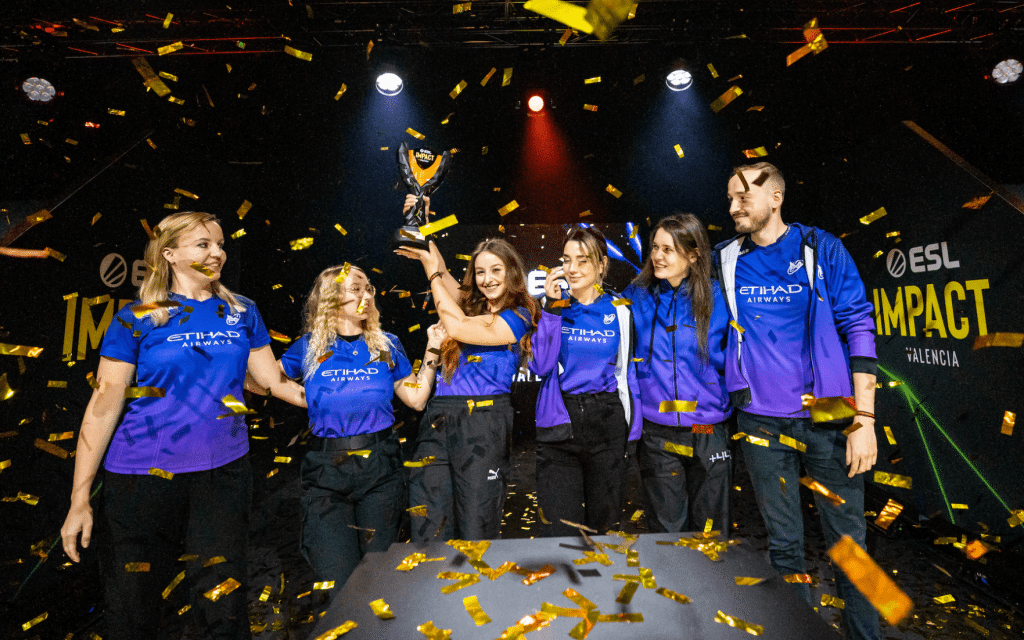 Nigma Galaxy's dominant female squad celebrating on stage amidst falling confetti after winning a championship