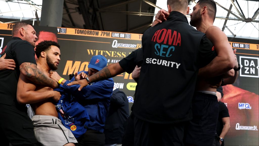 Moses Itauma and Filip Hrgovic scuffling during a weigh-in