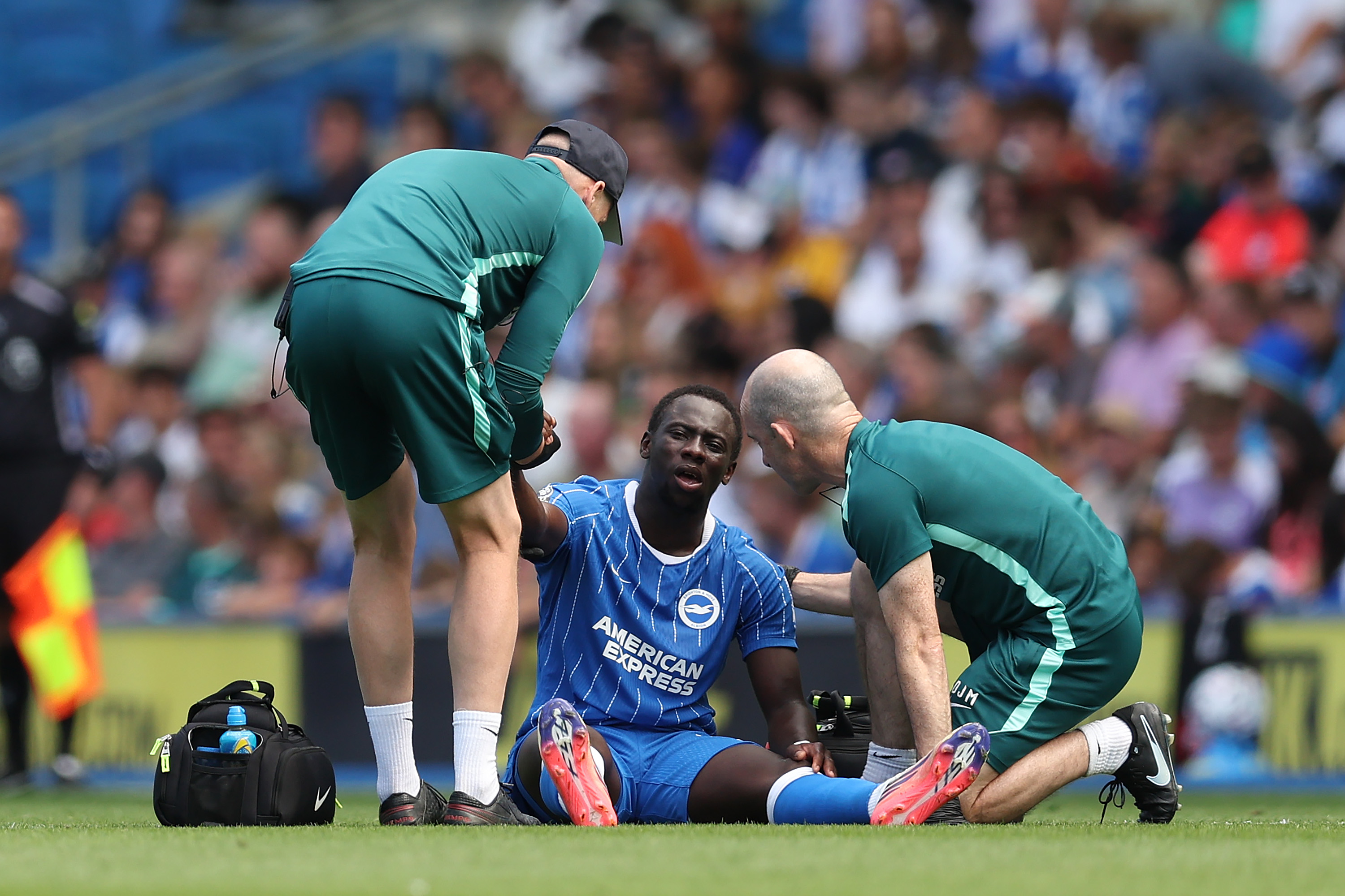 Yankuba Minteh of Brighton & Hove Albion receives treatment during the pre-season friendly match against Roma