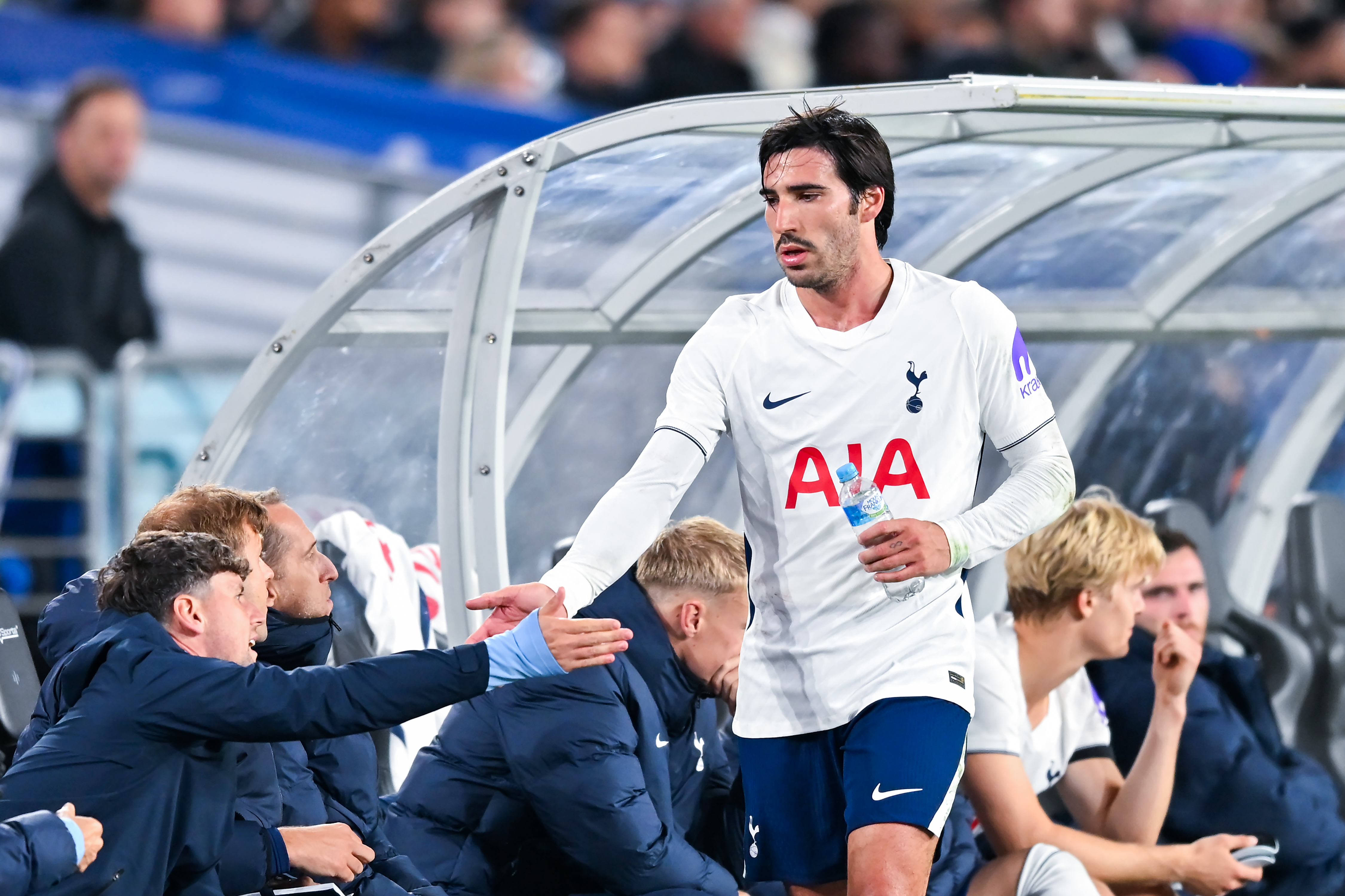 Spurs midfielder Sandro Tonali greets his teammates on the bench at Accor Stadium during a Sydney Super Cup clash with Chelsea in August 2026.