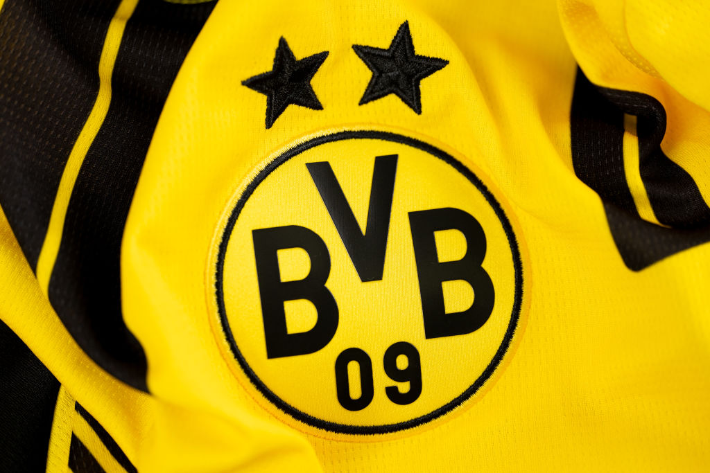 A close-up of the official Borussia Dortmund emblem taken during the 2024/25 UEFA Champions League kit presentation photoshoot.