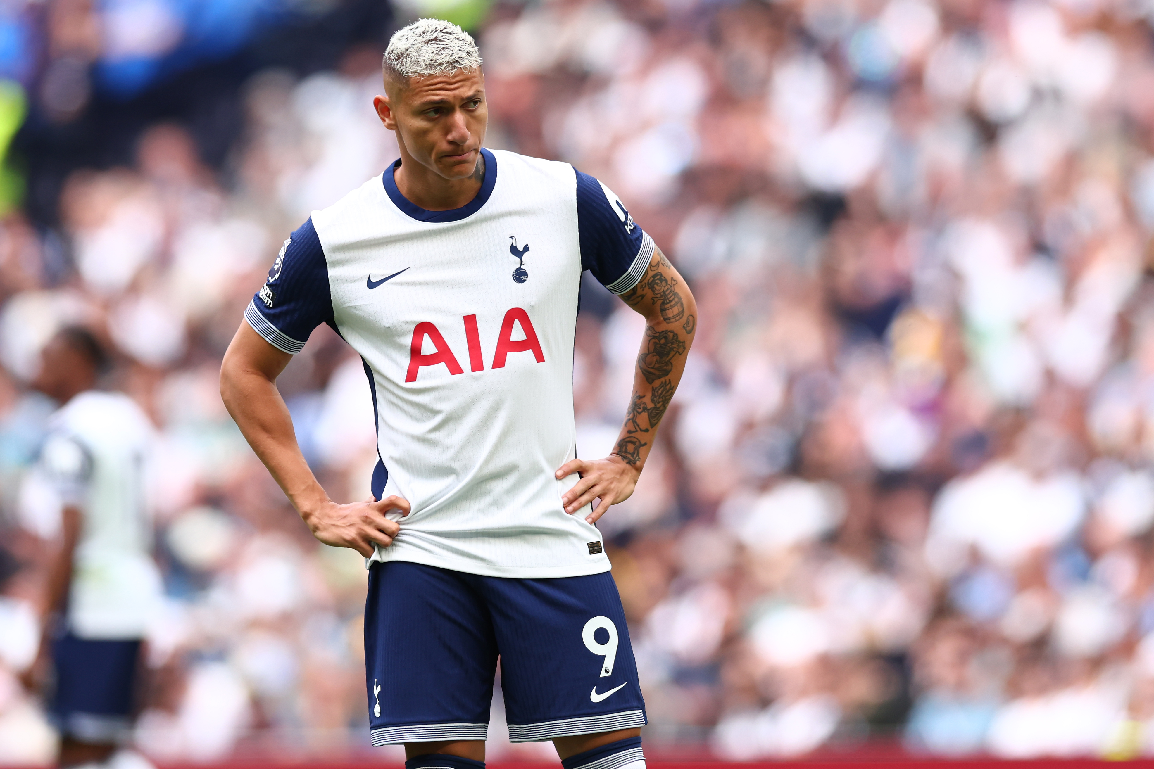 Tottenham forward Richarlison, hands on hips, dejected.