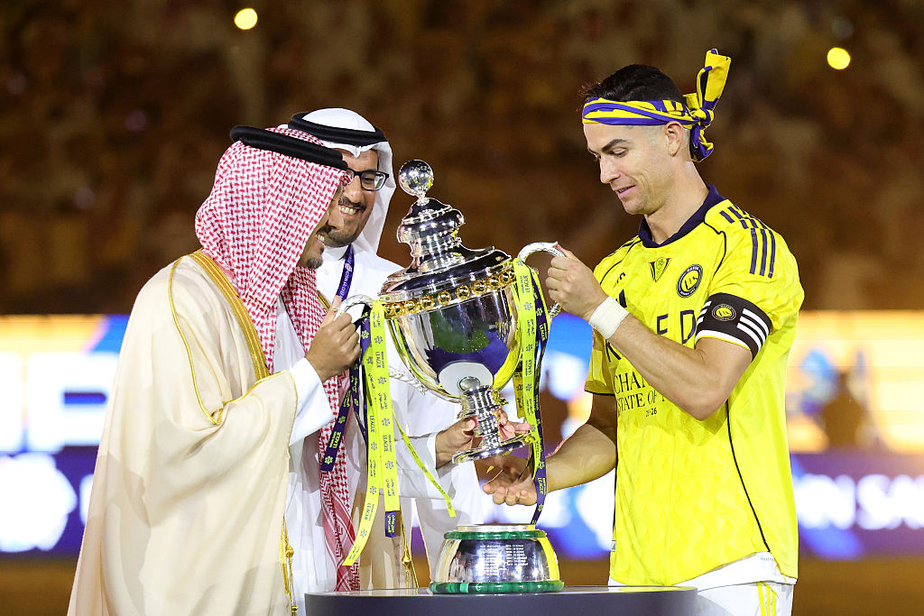 Al Nassr's Cristiano Ronaldo receiving the Saudi Pro League championship trophy.