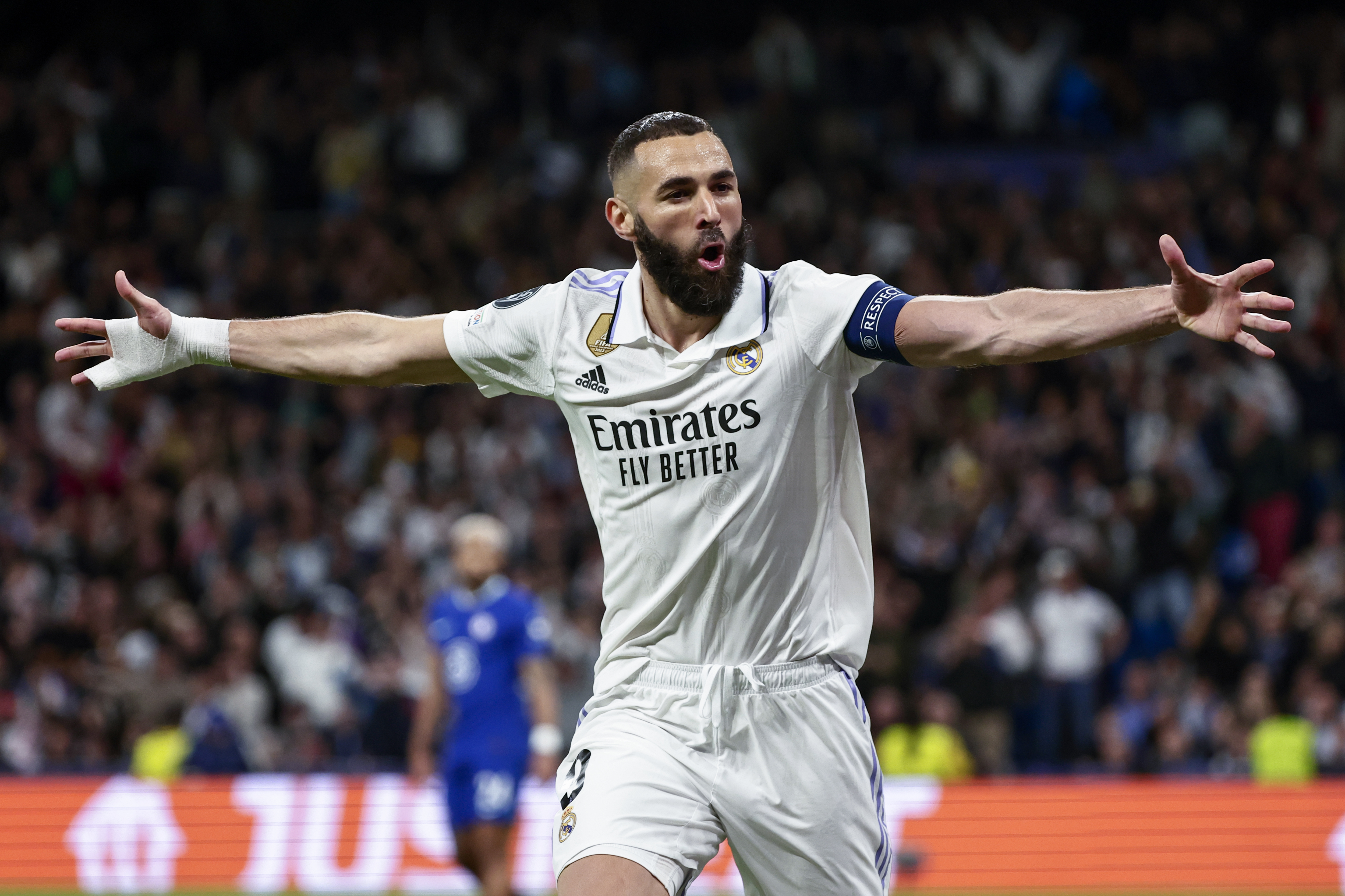 Karim Benzema celebrates a goal for Real Madrid against Chelsea in the Champions League in April 2023, arms outstretched.