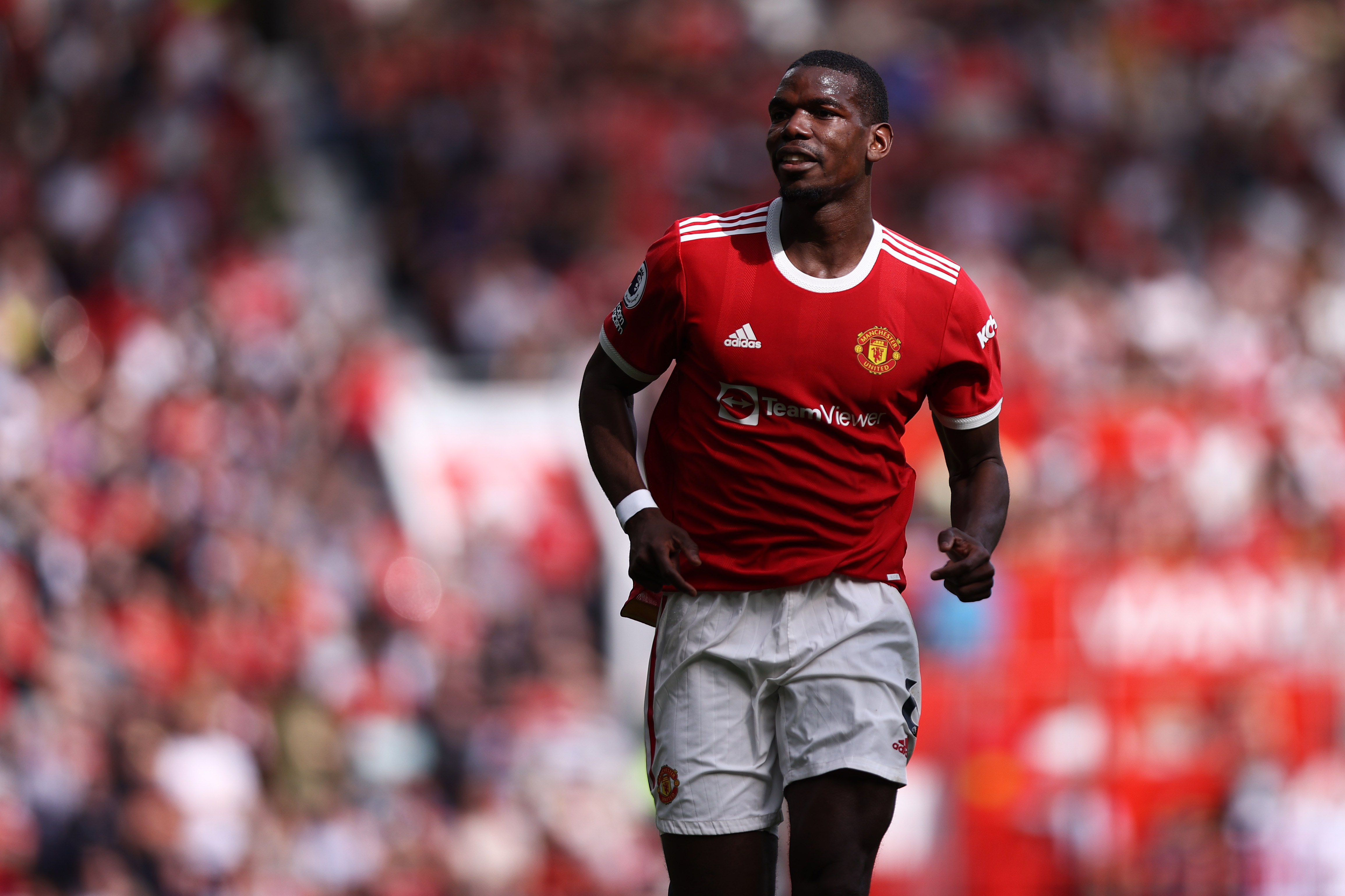 Paul Pogba in action for Manchester United against Norwich City in April 2022, running.