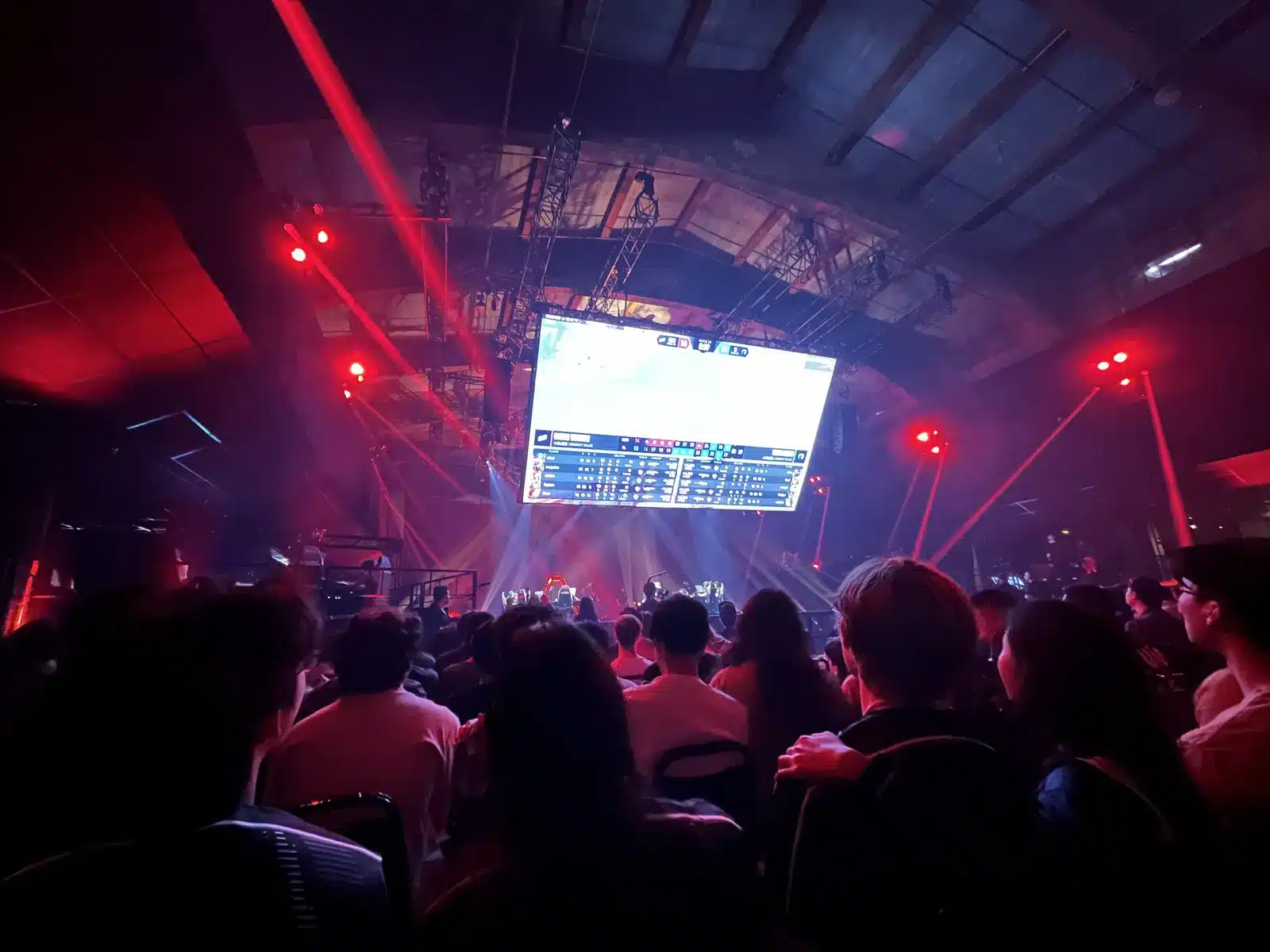 A crowd of spectators watching a match on a large screen at a Valorant Champions Tour event.