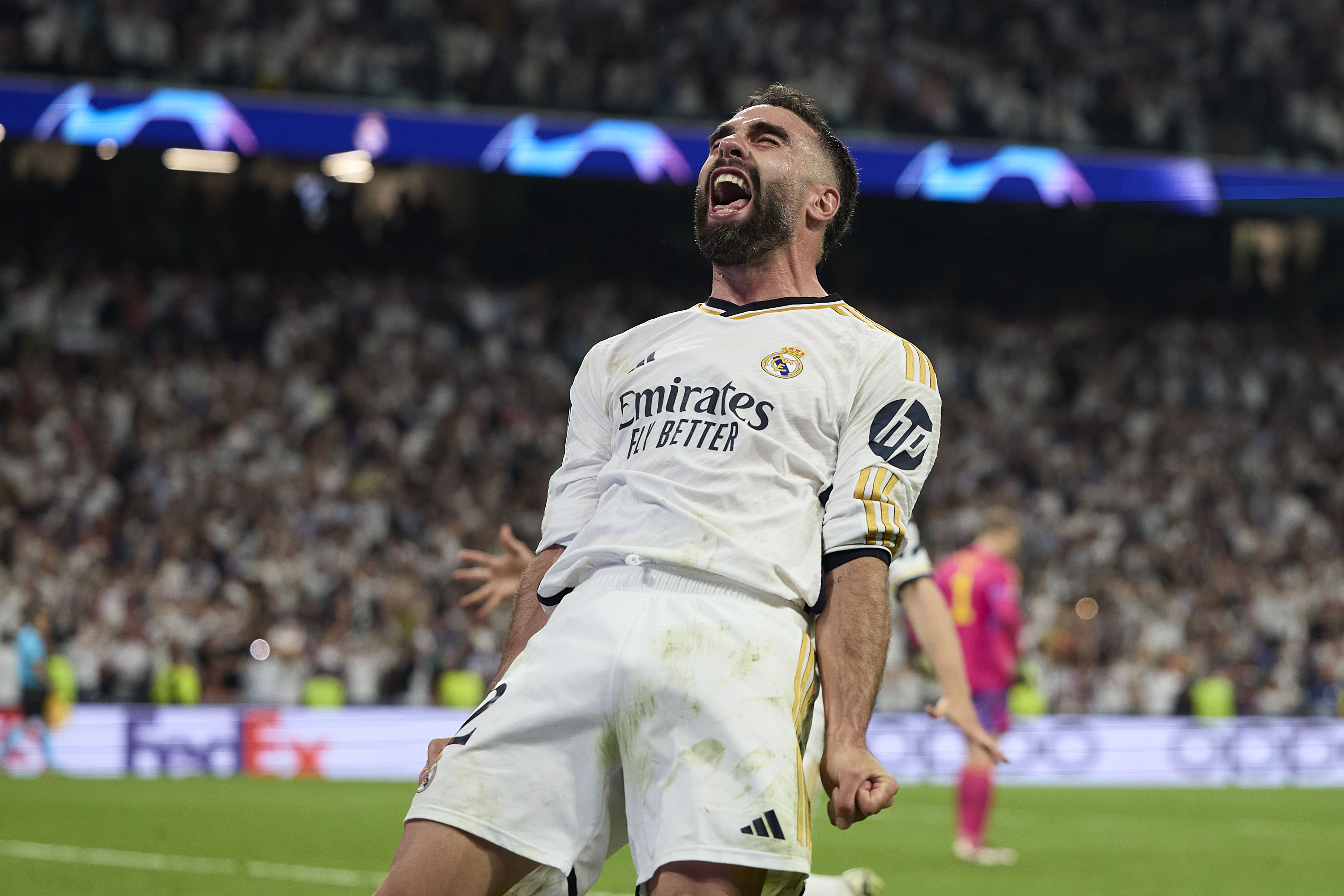 Real Madrid's Dani Carvajal enjoys a dramatic goal scored by Joselu during the second leg of the Champions League semi-final matchup with Bayern Munich in May 2024.