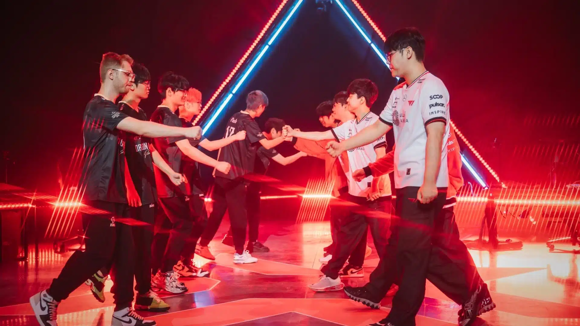Players from Dragon Ranger Gaming and T1 shaking hands on stage at VALORANT Champions 2025